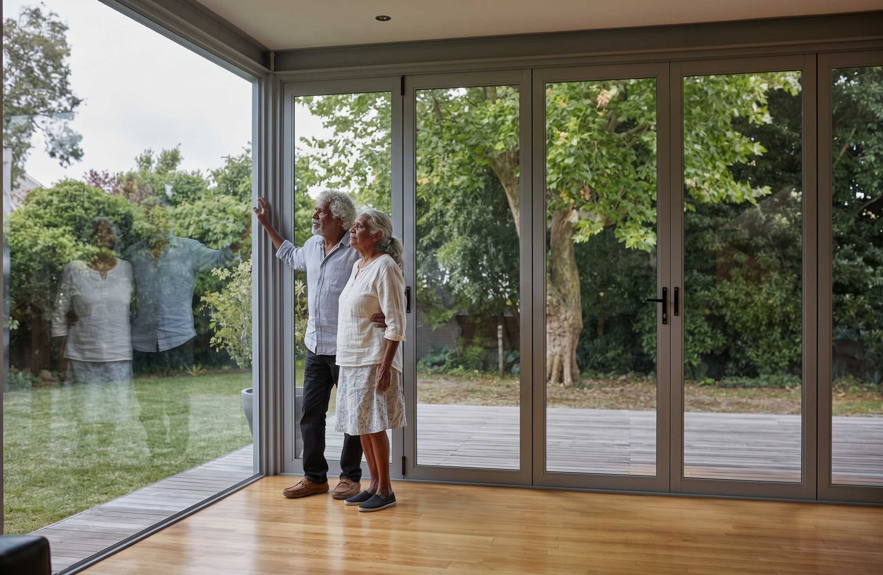 Corner bifold doors opening a living room onto the garden deck